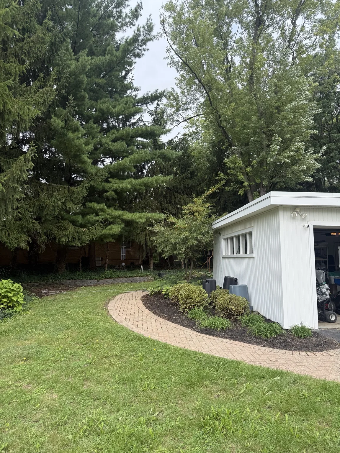 Clean curved walkway beside landscaped bed